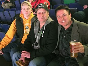 Humboldt Bronco Graysen Cameron, his father Tyler Cameron and Dawgs Nation Hockey Foundation founder Marty Richardson (L-R) are pictured at a Calgary Flames game in Calgary, AB in February 2019. Richardson visited Humboldt, Sask. the following day. Graysen is travelling to Colorado for a hockey tournament. Supplied
