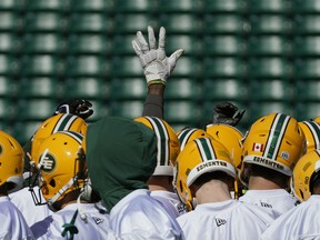 A lone hand is raised during a team huddle at the Edmonton Eskimos training camp held at Commonwealth Stadium in Edmonton on Monday, May 20, 2019.
