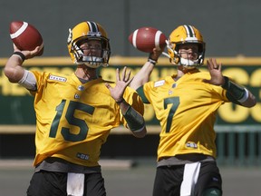 Edmonton Eskimos quarterbacks Logan Kilgore (15) and Trevor Harris (7) throw the ball during training camp in Edmonton on Sunday, May 19, 2019.