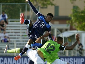 FC Edmonton's Bruno Zebi (top) collides with York9 FC's Simon Karlsson Adjei (bottom) during the second qualifying round of the 2019 Canadian Championship soccer match in Edmonton on Wednesday June 12, 2019. (PHOTO BY LARRY WONG/POSTMEDIA)