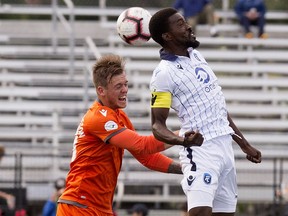 FC Edmonton's Tomi Ameobi  battles Forge FC's Alexander Achinioti-Jönsson   during Canadian Premier League action, in Edmonton Wednesday June 26, 2019. Photo by David Bloom