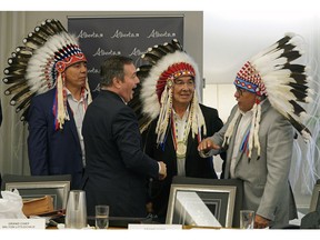 Alberta Premier Jason Kenney speaks with Treaty 8 Grand Chief Arthur Noskey, left, Treaty 6 Grand Chief Wilton Littlechild, middle, and Chiniki First Nation Treaty 7 Chief Aaron Young after he hosted his first meeting at Government House in Edmonton on Monday June 10, 2019, with First Nations Chiefs and Grand Chiefs about increasing Indigenous participation in the economy.