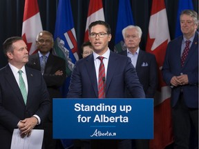 Premier Jason Kenney (left) and Minister of Justice and Solicitor General Doug Schweitzer (centre) discuss Bill 13: the Alberta Senate Election Act, at the Alberta Legislature in Edmonton Wednesday June 26, 2019.