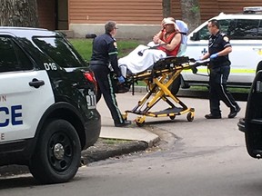 A man is treated by paramedics after police responded to a report of a shooting at a downtown apartment complex on Tuesday, June 25, 2019. Dylan Short/Postmedia