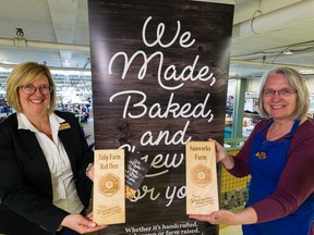 Old Strathcona Farmer's Market CEO Donna Lohstraeter, left, and Old Strathcona Farmers Market board of directors president Sheila Hamilton with Verified For You plaques at the Old Strathcona Farmers Market on Saturday, June 29, 2019.