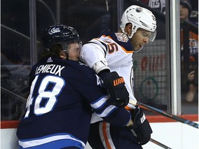 Winnipeg Jets forward Brendan Lemieux (left) absorbs an elbow from Edmonton Oilers defenceman Darnell Nurse in Winnipeg on Thurs., Dec. 13, 2018. Kevin King/Winnipeg Sun/Postmedia Network