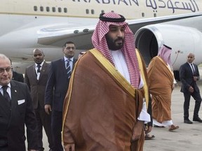 In this photo provided by the G20 Argentina press office, Saudi Arabia's Crown Prince Mohammed bin Salman deplanes at the airport in Buenos Aires, Argentina, Wednesday, Nov. 28, 2018. The prince, who will attend the two-day G20 Summit on Friday and Saturday, was taken to the Saudi embassy in Buenos Aires which is being guarded by dozens of police officers.