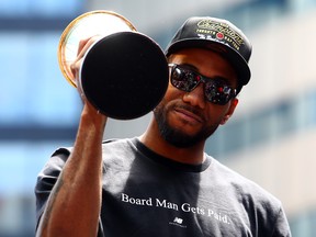 Kawhi Leonard #2 of the Toronto Raptors holds the MVP trophy during the Toronto Raptors Victory Parade.