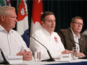 Alberta Premier Jason Kenney, centre, with Ontario Premier Doug Ford and Saskatchewan Premier Scott Moe on July 8.