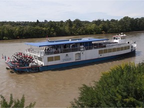 The Edmonton Riverboat sits unmoving on the North Saskatchewan River on Sunday morning after close to 300 passengers were rescued from the vessel overnight when the boat couldn't return to its dock.