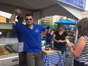 Kimon Kemeridis entertains the crowd at the Koutouki booth at this year's Taste of Edmonton.