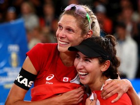Sarah Pavan, left, and Melissa Humana-Paredes of Canada celebrate after winning the gold medal match against April Ross of United States and Alix Klineman on day nine of the FIVB Beach Volleyball World Championships Hamburg 2019 at Rothenbaum Stadion on July 06, 2019, in Hamburg, Germany.