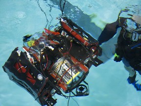 Members of the University of Alberta's Autonomous Robotic Vehicle Project (ARVP) perform final testing on their underwater robot (Auri 2.0) at Kinsmen Pool, in Edmonton Saturday July 13, 2019. The team is heading to the International RoboSub Competition in San Diego on July 29. Photo by David Bloom