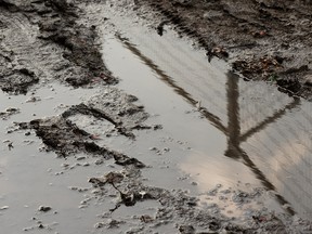 A muddy boot print is seen as crews continue to clean up the Chaos AB music festival site at Kinsmen Park in Edmonton, on Monday, July 29, 2019. Photo by Ian Kucerak/Postmedia