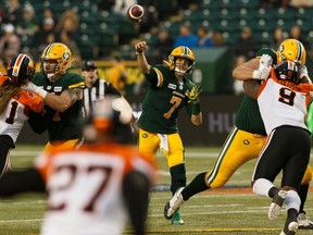 Edmonton Eskimos quarterback Trevor Harris (7) throws as B.C. Lions defensive linesmen are blocked during a CFL football game at Commonwealth Stadium in Edmonton, on Friday, June 21, 2019.