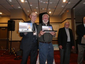 Former PWA Hercules air crew loadmasters Stu Russell, left, and Knut Ohm were each presented with a model Hercules airplane for organizing a recent "Herc Rats" reunion in Edmonton.