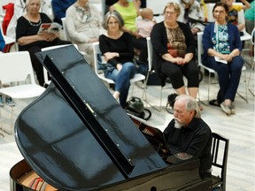 Pianist Cameron Robert Watson, left, and narrator Robert Klakowich perform An Old-Fashioned Fairy Tale, composed by Peter Jancewicz, during the launch of Alberta Pianofest at city hall in Edmonton on Thursday, July 4, 2019.