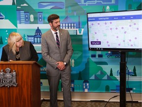 Coun. Bev Esslinger, left, and Mayor Don Iveson demonstrate SafeCityYEG, a web-based mapping tool that allows Edmontonians to report where they feel safe or unsafe in public spaces, during a news conference at city hall in Edmonton on Wednesday, July 10, 2019.