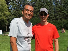 Reconciliaction creator Stan Wesley, left, prepares to go for a run with Brian McCosh, right. Brian's son Patrick, far right, is riding his bike at the reconciliation event in Edmonton's Victoria Park on Sunday.