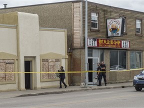 Edmonton Police raided a row of businesses along 111 Avenue near 93 Street on July 24, 2019. Agents from the Canada Revenue Agency could be seen handling computers and hard drives.