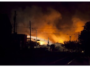 In this file photo taken on July 6, 2013 firefighters douse blazes after a freight train loaded with oil derailed in the middle of Lac-Megantic, Que.