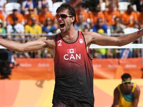 Canada's Ben Saxton celebrates after winning the men's beach volleyball qualifying match between Brazil and Canada at the Beach Volley Arena in Rio de Janeiro on August 9, 2016, for the Rio 2016 Olympic Games.