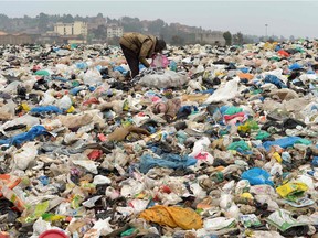 A man searches through waste at the Ngong town dumping site, 30 kilometres southwest of Nairobi, on August 24, 2017.