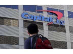 A man walks across the street from a Capital One location in San Francisco on July 16, 2019. A hacker gained access to personal information from more than 100 million Capital One credit applications, including six million from Canada, the bank said Monday as federal authorities arrested a suspect in the case.