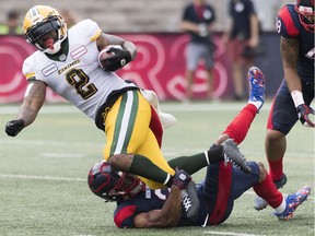 Montreal Alouettes Patrick Levels, bottom, tackles Edmonton Eskimos' C.J. Gable during first half CFL football action in Montreal on Saturday, July 20, 2019.