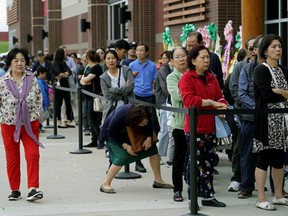 Hundreds of shoppers lined up for hours outside the new H-Mart Asian supermarket in south Edmonton to get a chance to shop on the grand opening day of the store on Thursday July 11, 2019. (PHOTO BY LARRY WONG/POSTMEDIA)