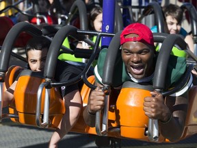 The Edmonton Eskimos' Vontae Diggs enjoys the rides during Monday Morning Magic at K-Days in Edmonton on Monday, July 22, 2019. 500 children with special needs between the ages of three and 12 had the fairgrounds to themselves during the 42nd annual event.
