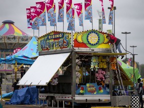 Crews set up games and attractions at K-Days, in Edmonton Thursday, July 18, 2019.