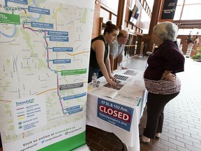 Meagan Brooks, stakeholder relations coordinator at TransEd, speaks to Heather Lee on Wednesday, July 24, 2019, during an open house about the latest road closure to hit downtown at the intersection of 97 Street and 102 Avenue.