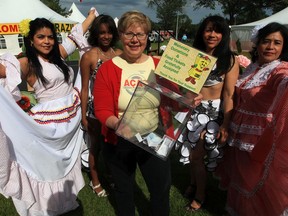 Raising money for the food bank is always a key part of the Heritage Festival. A 2013 photo shows Edmonton Latin Festival Dancers Ingrid Torres, Lili Baly, Juana Lagua, and Isis Soldevala with Edmonton Food Bank executive director Marjorie Bencz.