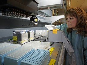 Dr. Stacey Hume, genetics laboratory head at University Hospital, looks at some blood samples in the laboratory where a newborn screening program, that includes screening for four more conditions, has been implemented.