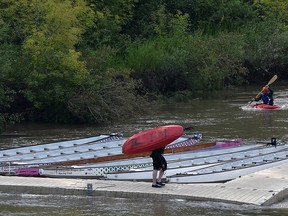 A kayaker paddling up river to the dock as another prepares to enter the North Saskatchewan River where the water levels have risen, next to Dawson Park in Edmonton, July 8, 2019. Ed Kaiser/Postmedia