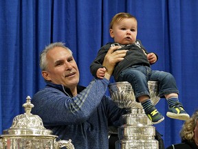 Calahoo resident Braxton Majeau, 13 months, poses for a photo with St. Louis Blues head coach Craig Berube in the hamlet of Calahoo northwest of Edmonton on Tuesday, July 2, 2019. Berube brought the Stanley Cup and the Campbell Conference Championship trophy to his home town after his team won the NHL Stanley Cup championship. (Photo by Larry Wong/Postmedia)
