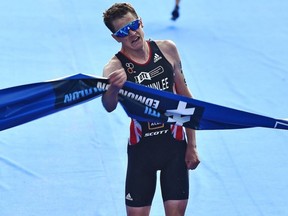 Great Britian Jonathan Brownlee crosses the finishline to win the Elite Men during the ITU World Triathlon at Hawrelak Park in Edmonton, July 20, 2019.