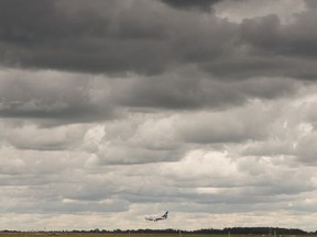 A Westjet flight lands at Edmonton International Airport as a rainstorm rolls through in Leduc, on Wednesday, July 3, 2019. Photo by Ian Kucerak/Postmedia