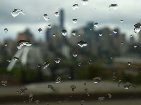 Rain drops on a window with city skyline in back, as the off and on again showers continue in Edmonton, June 24, 2019. Ed Kaiser/Postmedia