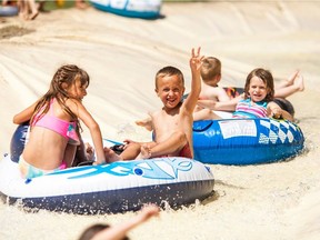 Children float down the Whitecourt River Slides, which divert water from a groundwater-fed pond to run down a massive slip-and-slide and back into a pond. It's become a major tourist attraction as part of Whitecourt's Rotary Park.