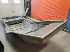 A damaged aluminum boat, recovered from the shores of the Nelson River police searching for fugitive murder suspects Kam McLeod and Bryer Schmegelsky, is seen on August 4, 2019. .