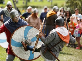 A viking combat demonstation is undertaken by the Ravens viking reenactors in the Viking Village at Heritage Festival at Hawrelak Park in Edmonton, on Saturday, Aug. 3, 2019. Photo by Ian Kucerak/Postmedia