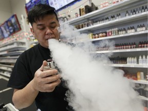 Ben Joy Dola demonstrates how CBD (cannabidiol) additives are vaped at the Digital Imports E-Cig Vape shop in Edmonton, Alberta on Wednesday, December 21, 2016. File photo.