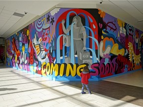 Camlin Cutler (3-years-old) stops to check out a piece of artwork created by Edmonton mural artist Jill Stanton at Kingsway Mall in Edmonton on Thursday May 2, 2019. The mall has partnered with the Rust Magic International Street Mural Festival and has invited local and international artists to create a collection of murals on over 6,000 square feet of wall space around the mall.