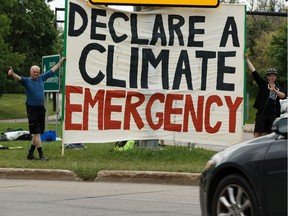 Climate justice campaigners with Extinction Rebellion called for a climate emergency to be called while demonstrating on 109 Street near the High Level Bridge in Edmonton, on Tuesday, July 16, 2019.