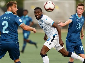 FC Edmonton's Tomi Ameobi (18) battles HFX Wanderers FC's Peter Schaale (2) and Scott Firth (15) during the first half of a Canadian Premier League soccer game at Clarke Stadium in Edmonton, on Wednesday, July 31, 2019. Photo by Ian Kucerak/Postmedia