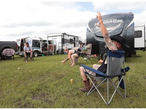 Jeff Ternowsky, from Edmonton, celebrates a successful shot during a game of beer darts at the Big Valley Jamboree in Camrose, Alta. on August 1, 2019. Dylan Short/Postmedia