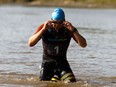 Phil Wong with Team 1 exits the North Saskatchewan River during the inaugural SwimRun held in Edmonton, on Sunday, Aug. 4, 2019.