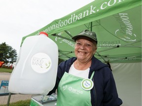 Edmonton's Food Bank volunteer Claudia Langlois collects donations during the last day of Heritage Festival at Hawrelak Park in Edmonton, on Monday, Aug. 5, 2019.